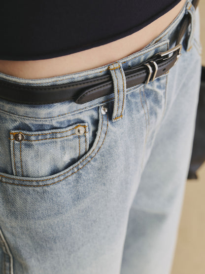 Close-up of light wash blue structured horseshoe jeans in cotton denim