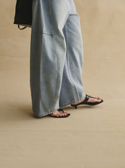 Close-up of Structured horseshoe jeans in light wash blue